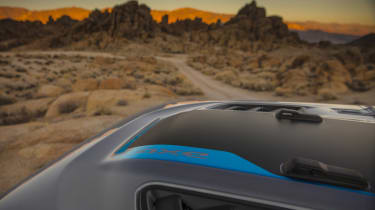 The hood graphic on the 2021 Jeep® Wrangler Rubicon 4xe includes a Surf Blue accent.