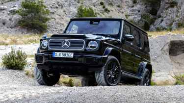 Mercedes G 580 driving over rocky terrain