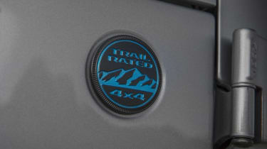 Surf Blue coloring on the Trail Rated badge denotes the 4xe version of the 2021 Jeep® Wrangler.