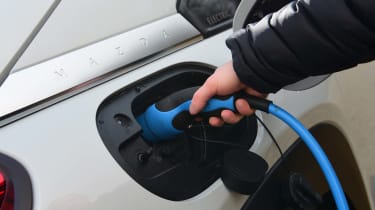 plugging in electric car charger