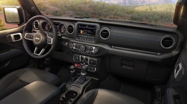 Interior of the 2021 Jeep® Wrangler Rubicon 4xe includes Surf Blue accent stitching on seats and interior trim.